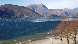 a body of water with mountains in the background at Foresteria Lombarda La Spiaggia in Lierna