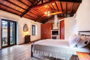 a bedroom with a large bed and a fireplace at Flabouriaris Estate in Anafonítria