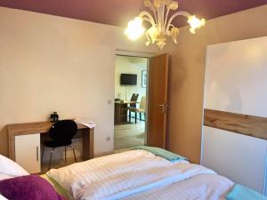 a bedroom with a bed and a desk and a table at Apartment "Herbert" Sonnleitn/Nassfeld in Sonnenalpe Nassfeld