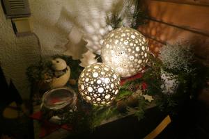 two balls are sitting on a table with christmas decorations at Haus Mälla in Sankt Gallenkirch