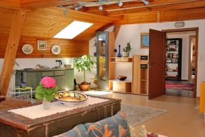 a living room with a table and a kitchen at Landhaus Tangern in Millstatt +27 photos