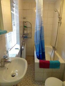 a bathroom with a sink and a shower curtain at Sleep in Hamburg St. Pauli in Hamburg
