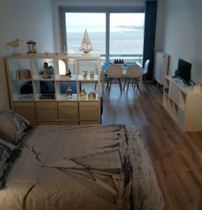 a living room with a bedroom with a view of the ocean at Zeewende 18 in Zeebrugge