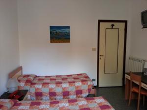 Ένα ή περισσότερα κρεβάτια σε δωμάτιο στο Hotel Mignon Posta