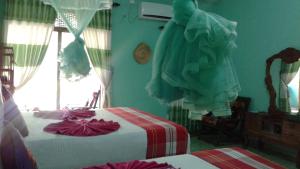Postel nebo postele na pokoji v ubytování Flower Inn