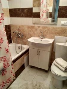 y baño con lavabo, aseo y bañera. en Apartments near Arena on Syhivska en Leópolis