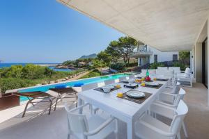 an outdoor dining area with a table and chairs at Villa Seablue by Esteva Emerald Stay in Alcudia