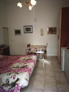 a bedroom with two beds and a table in it at Casa Teatro Greco in Catania