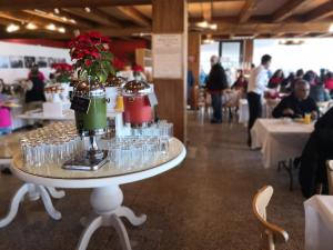 a table with glasses and a vase on it at Hacienda Panoaya in Amecameca de Juárez