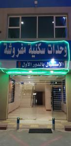 een bord aan de voorzijde van een gebouw bij Sanabel Al Mish'an Furnished Units in Al Jithāmīyah