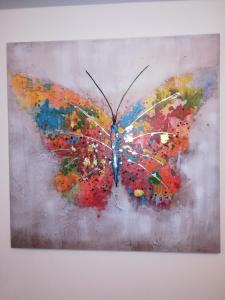 a painting of a butterfly on a wall at Butterfly in Čačak