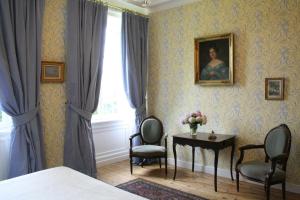 a bedroom with a table and two chairs and a window at Bruce Castle in Brix