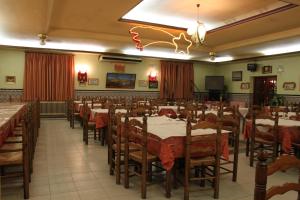 a banquet hall with tables and chairs in a room at Hostal Santa Ana in Madridejos