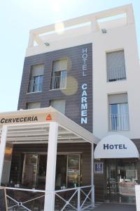 a hotel with a sign on the front of it at Hotel Carmen in La Cala de Mijas