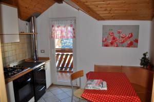 a kitchen with a table with a red table cloth at Silvano Fanti in Rumo