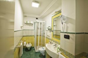 a bathroom with a sink and a toilet at Grand Hotel Il Ninfeo in Gaeta
