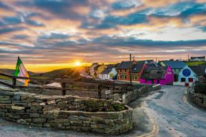 a village with a stone wall and a sunset at Doolinsunset in Doolin