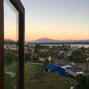 a view of a mountain from a window at Cabaña Hagemann in Puerto Varas