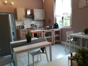 a kitchen with a table and chairs in a room at Bergamo Bassa in Bergamo