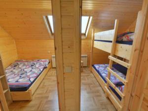 a room with two bunk beds in a cabin at Domek nad Lasem in Koniaków