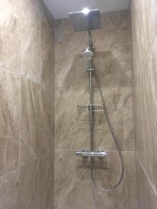 a shower with a shower head in a bathroom at Ferienhaus Adele in Bad Neuenahr-Ahrweiler