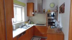a kitchen with a sink and a microwave at Casa Landim in Landim