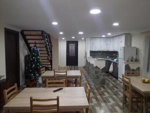 a kitchen with tables and a christmas tree in it at Guesthouse Zaqara in Borjomi