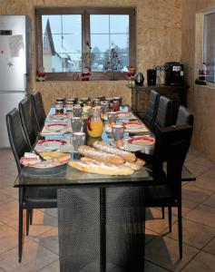 a table with plates of food on it in a kitchen at CHEZ SANDRINE in Surbourg