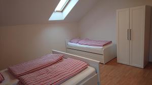 a bedroom with two beds and a skylight at Villa Park Lipno 206 in Lipno nad Vltavou