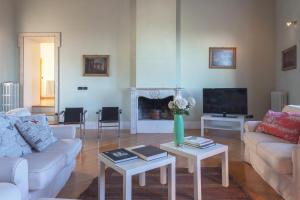 a living room with two couches and a tv at Terrazza su Assisi Guest House in Perugia