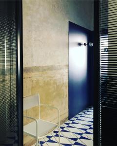a hallway with a bench and a wall with a light at PrimoPianoPosillipo in Naples