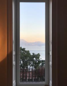 an open window with a view of the ocean at PrimoPianoPosillipo in Naples