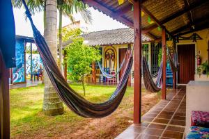 a couple of hammocks hanging from a house at Floripa Surf Hostel in Florianópolis