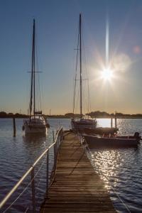 two boats are docked at a dock in the water at Traumlage-Maasholm in Maasholm