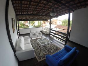 a view of a living room with a couch and chairs at Pousada do Tesouro in Paraty