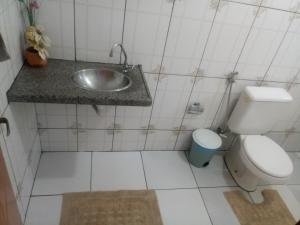 a small bathroom with a sink and a toilet at Casa Temporada com Ar cond e Wifi in Barreirinhas