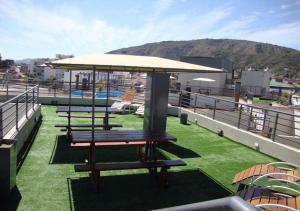a group of picnic tables on top of a roof at Departamento Carlos Paz, Centro in Villa Carlos Paz