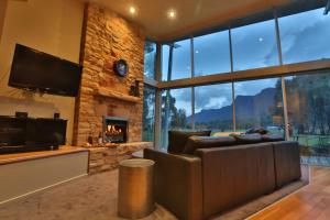 a living room with a couch and a fireplace at Ironstone Romantic Couples Retreat in Halls Gap