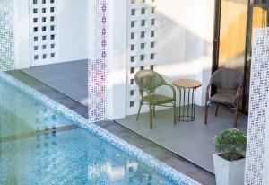 a balcony with chairs and a table on a building at Chaanburi Boutique Resort in Chanthaburi