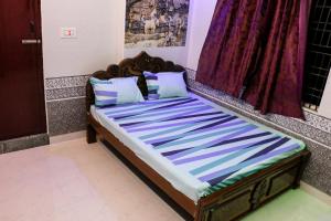 a bed sitting in a room with at Sri Priya Lodge in Dharmapuri