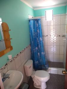 a bathroom with a toilet and a sink at Samana Wasi in Yanque