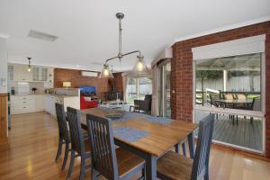 a kitchen and dining room with a table and chairs at Abbey Rose - Bright, VIC in Bright