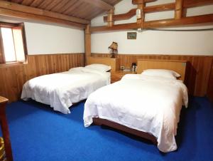 Postel nebo postele na pokoji v ubytování Jinsha Old Street B&B