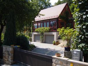 a house with a garage and a fence at Winzerhaus Rissweg 15 in Dresden