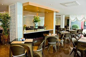 a restaurant with tables and chairs and a bar at Roseate Chiang Mai in Chiang Mai