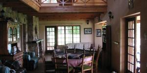 a living room with a couch and a table at Field and Stream in Dullstroom