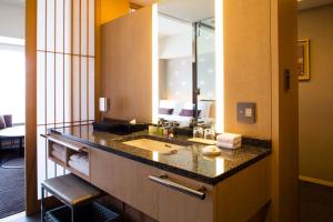 a bathroom with a sink and a large mirror at The Capitol Hotel Tokyu in Tokyo +135 photos