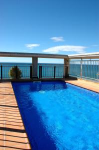 a swimming pool on the balcony of a house at Apartamentos las Palmas VII Family only in Salou