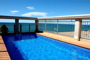 a swimming pool on the balcony of a house at Apartamentos las Palmas VII Family only in Salou
