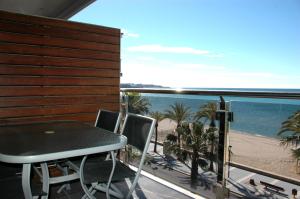 a table and chairs on a balcony with a view of the beach at Apartamentos las Palmas VII Family only in Salou